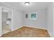 Bedroom area with hardwood flooring, natural light, and neutral walls at 735 Wilbrown Cir, Charlotte, NC 28217