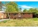 Charming single-story brick home with a cozy front porch and a well-maintained yard at 735 Wilbrown Cir, Charlotte, NC 28217