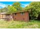 Charming single-Gathering home with brick exterior, covered patio, and lush green yard at 735 Wilbrown Cir, Charlotte, NC 28217