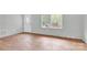 Bright living room with hardwood floors and a large window at 735 Wilbrown Cir, Charlotte, NC 28217