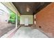 Covered patio, brick walls, and concrete, perfect for outdoor living and entertaining at 735 Wilbrown Cir, Charlotte, NC 28217