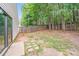 Spacious backyard featuring a wood fence, lush greenery, and a concrete patio at 8027 Bristle Ln, Charlotte, NC 28214