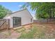 View of a backyard with a wood fence, grass, and patio sliding glass door at 8027 Bristle Ln, Charlotte, NC 28214