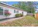Backyard features a well-maintained lawn, flowers, and a privacy fence perfect for outdoor enjoyment at 8027 Bristle Ln, Charlotte, NC 28214