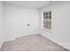 This bright bedroom has neutral carpet and a double door closet at 8027 Bristle Ln, Charlotte, NC 28214