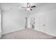 Bright bedroom features neutral carpet, ceiling fan and ensuite bathroom at 8027 Bristle Ln, Charlotte, NC 28214