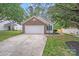 Charming home featuring a brick and siding facade, a two-car garage, and a driveway at 8027 Bristle Ln, Charlotte, NC 28214