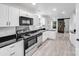 Modern kitchen featuring white cabinets, stainless steel appliances, and granite countertops at 8027 Bristle Ln, Charlotte, NC 28214