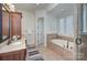 Bathroom featuring a soaking tub, and vanity with granite counters at 809 Verney Ln, Charlotte, NC 28226