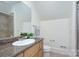 Well-lit bathroom with a shower with glass door and granite countertop vanity at 809 Verney Ln, Charlotte, NC 28226