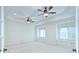 Spacious bedroom featuring tray ceiling, two ceiling fans, two windows with seating at 809 Verney Ln, Charlotte, NC 28226