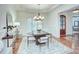 Elegant dining room with modern chandelier, wainscoting, and hardwood floors at 809 Verney Ln, Charlotte, NC 28226