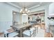 Open dining room with modern chandelier and hardwood floors leading to living area at 809 Verney Ln, Charlotte, NC 28226