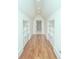 Hallway with hardwood floors, white walls and built-in shelving at 809 Verney Ln, Charlotte, NC 28226