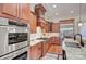 Well-equipped kitchen with stainless steel appliances, granite counters and wood cabinets at 809 Verney Ln, Charlotte, NC 28226