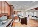 Modern kitchen with granite counters, wood cabinets, stainless appliances, and an eat-in island at 809 Verney Ln, Charlotte, NC 28226