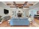 Living room with beamed ceilings, a stone fireplace, and hardwood floors at 809 Verney Ln, Charlotte, NC 28226