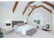 Spacious main bedroom featuring beamed ceilings, a ceiling fan, and a large window at 809 Verney Ln, Charlotte, NC 28226