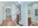 Elegant staircase with wooden handrail and wrought iron spindles leading to the upper level at 809 Verney Ln, Charlotte, NC 28226