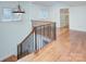 Bright staircase with hardwood floors and decorative wrought iron railing leading upstairs at 809 Verney Ln, Charlotte, NC 28226