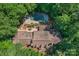 The aerial shot showcases a luxurious home with a beautiful pool, surrounded by lush greenery and mature trees at 8400 Prince Valiant Dr, Waxhaw, NC 28173