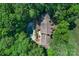 An aerial view reveals a private estate surrounded by lush trees, highlighting a sparkling pool and patio at 8400 Prince Valiant Dr, Waxhaw, NC 28173