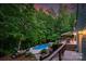 Backyard features a pool, deck, fire pit, and mature trees; ideal for outdoor living and entertaining at 8400 Prince Valiant Dr, Waxhaw, NC 28173