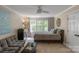 Bright bedroom featuring a ceiling fan, large window, and a comfortable queen-sized bed at 8400 Prince Valiant Dr, Waxhaw, NC 28173
