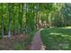 A brick path leads to this house through a wooded area at 8400 Prince Valiant Dr, Waxhaw, NC 28173