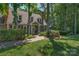View of home through the trees, brick walkway to door at 8400 Prince Valiant Dr, Waxhaw, NC 28173