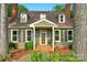 Inviting front exterior with a brick walkway and a charming front door, framed by lush plants at 8400 Prince Valiant Dr, Waxhaw, NC 28173