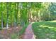 Beautiful home set back from the street, showcasing a brick path and serene greenery at 8400 Prince Valiant Dr, Waxhaw, NC 28173
