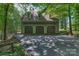 A three-car garage offers ample parking and storage space, nestled among the trees at 8400 Prince Valiant Dr, Waxhaw, NC 28173