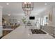 Open concept kitchen featuring large island cooktop, stainless appliances, and seamless flow to living area at 8400 Prince Valiant Dr, Waxhaw, NC 28173