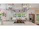 Modern kitchen with large island cooktop, stainless steel appliances, and a view of the backyard at 8400 Prince Valiant Dr, Waxhaw, NC 28173