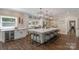 Spacious kitchen with large island, seating, modern appliances, and wine storage, perfect for entertaining at 8400 Prince Valiant Dr, Waxhaw, NC 28173