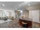 Open-concept living room with hardwood floors and a granite countertop island in the basement at 8400 Prince Valiant Dr, Waxhaw, NC 28173