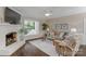 Inviting living room with fireplace, large window, and comfortable seating arrangement at 8400 Prince Valiant Dr, Waxhaw, NC 28173