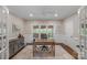 Home office with natural light from large window and stylish built-in cabinets offers a great work-from-home space at 8400 Prince Valiant Dr, Waxhaw, NC 28173