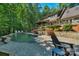 The beautiful pool area features stone accents, lush landscaping, and comfortable seating, perfect for relaxing at 8400 Prince Valiant Dr, Waxhaw, NC 28173
