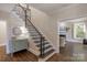 Foyer view with a staircase, hall table, and doorway to living room at 8400 Prince Valiant Dr, Waxhaw, NC 28173
