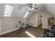 Bright workout room with skylights, ceiling fan, and hardwood floors, perfect for exercise equipment at 8400 Prince Valiant Dr, Waxhaw, NC 28173