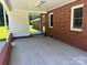 Covered back porch with brick detailing and a view of the backyard at 907 Mcgowan Rd, Shelby, NC 28150
