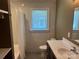 This bathroom features a shower/tub combo, a single sink, and a window for natural light and ventilation at 907 Mcgowan Rd, Shelby, NC 28150
