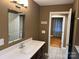 Vanity with modern countertop, undermount sink, and a mirror, plus an inviting view to another room at 907 Mcgowan Rd, Shelby, NC 28150
