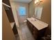 This bathroom features a shower/tub combo, a single sink, and a window for ventilation and natural light at 907 Mcgowan Rd, Shelby, NC 28150