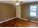 Bright bedroom featuring hardwood floors, a ceiling fan, and a window with backyard views at 907 Mcgowan Rd, Shelby, NC 28150