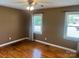 This bedroom features hardwood floors, neutral paint, two windows for natural light, and a ceiling fan at 907 Mcgowan Rd, Shelby, NC 28150