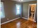 This bedroom has hardwood floors and two windows, and offers an attached bathroom and a ceiling fan at 907 Mcgowan Rd, Shelby, NC 28150