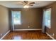 Bedroom featuring hardwood floors, a ceiling fan, and two windows with blinds and curtains at 907 Mcgowan Rd, Shelby, NC 28150